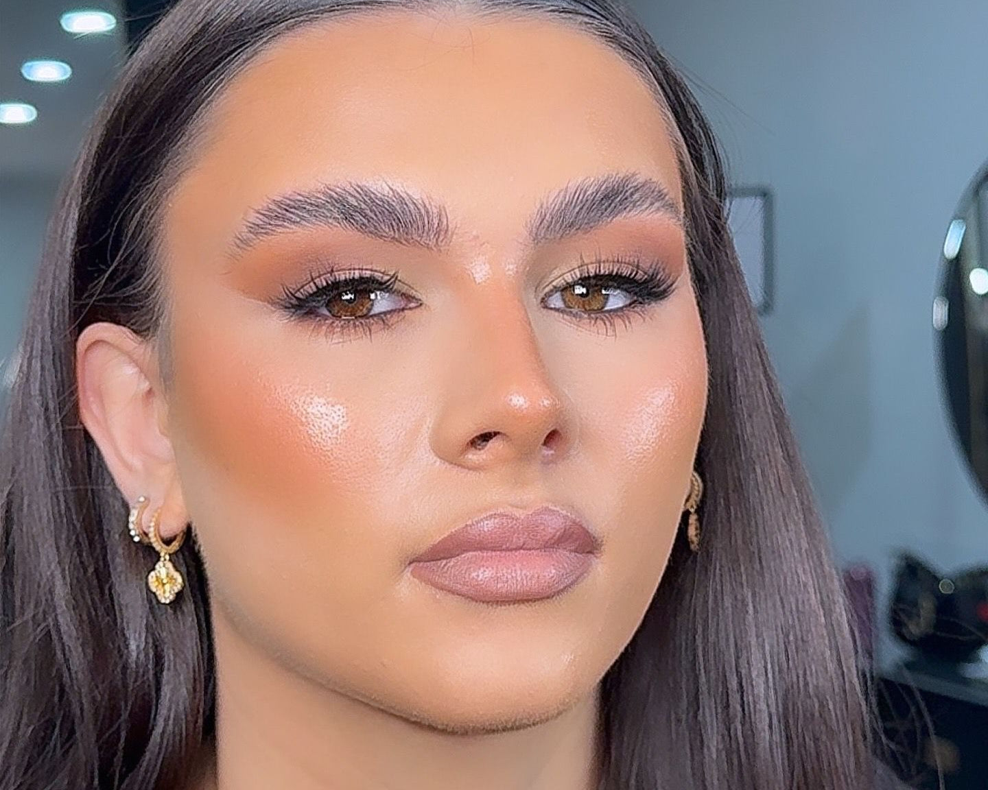 Close-up of a person with makeup looking directly at the camera.